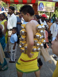 heavy bells hanging on the body of a chinese believer